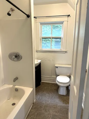 a bathroom with a sink a toilet and a bathtub