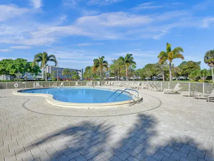 a view of a swimming pool with a yard