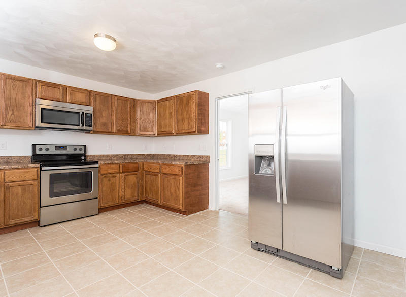 5261 Saunders Road Vinton, VA 24179 - Photo 14 of 47 a kitchen with granite countertop a refrigerator and a stove top oven