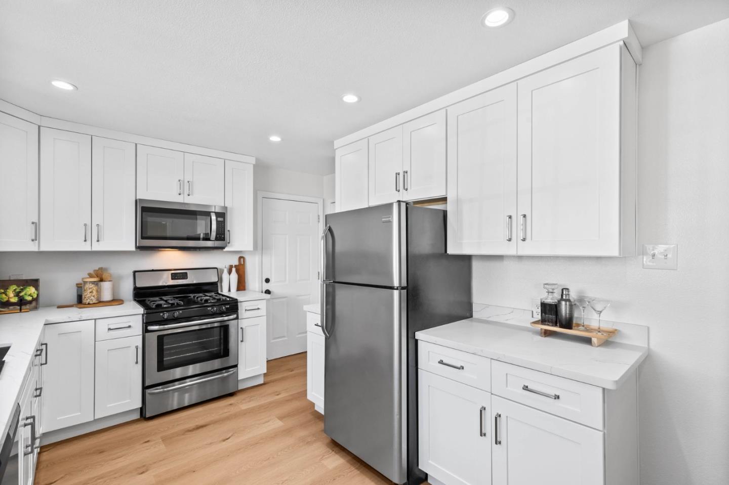 20860 Baker Road Castro Valley, CA 94546 - Photo 9 of 21 a kitchen with white cabinets and stainless steel appliances