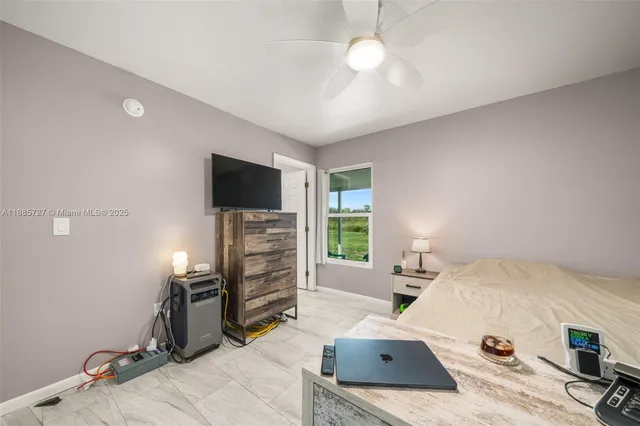 a bedroom with furniture and a flat screen tv