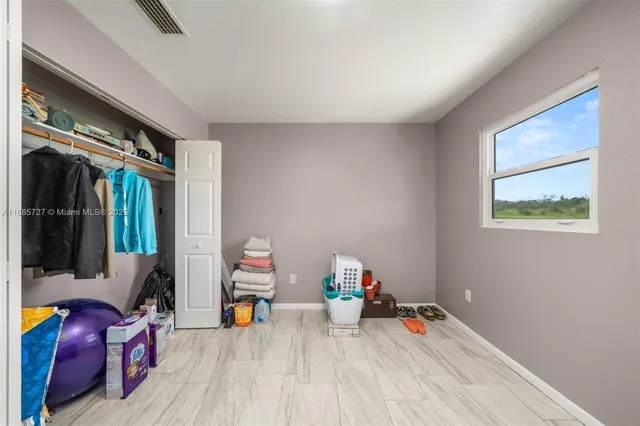 a view of room with wooden floor and furniture