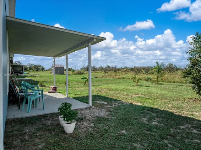 a view of a table and chairs in the garden