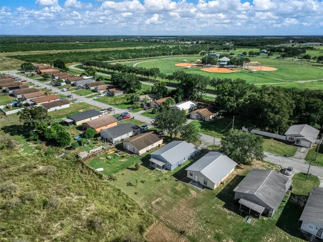 an aerial view of a houses with a yard