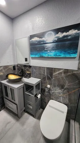a stove top oven sitting inside of a kitchen