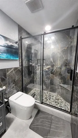 a bathroom with a glass shower door