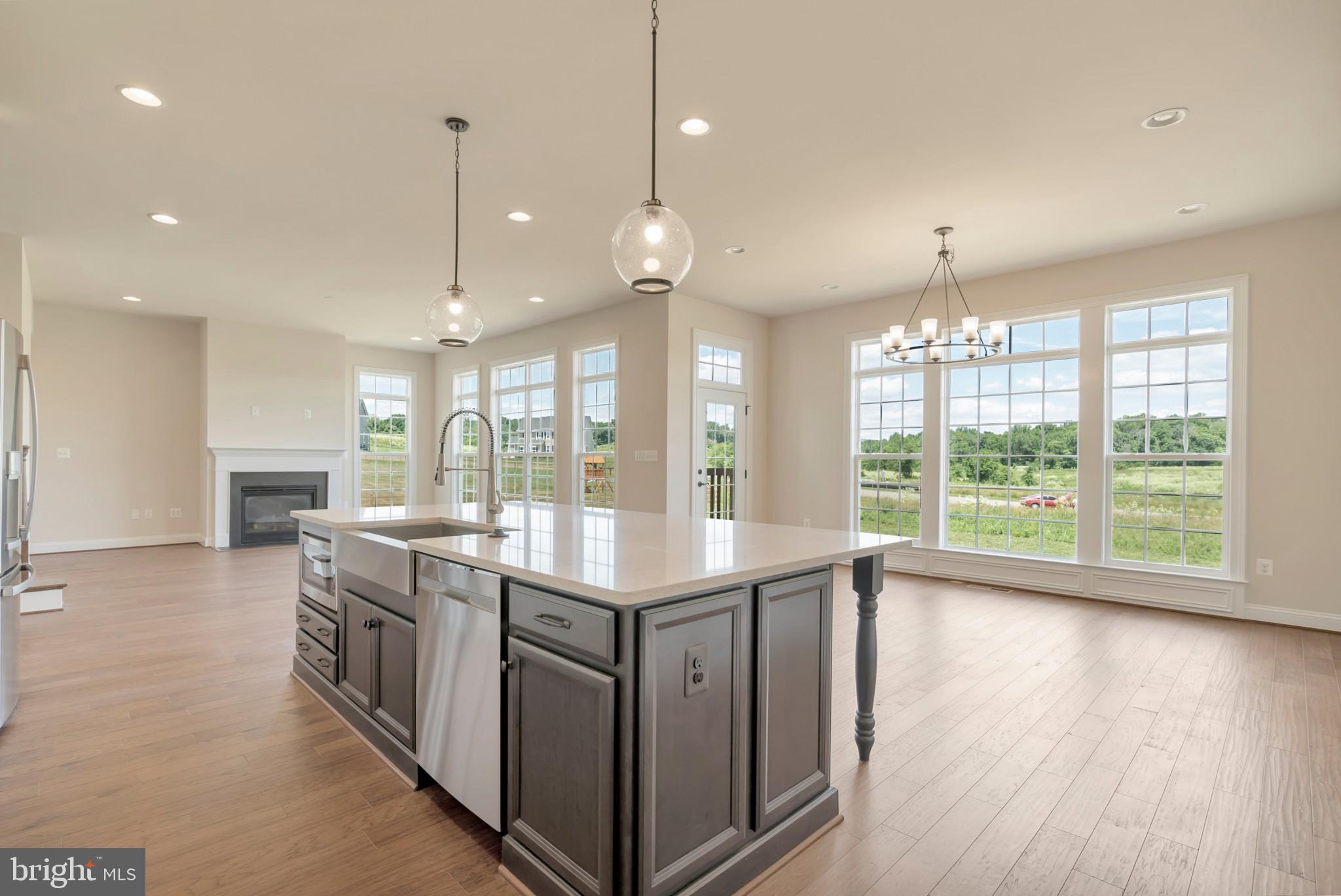 Red Oak Road Cross Junction, VA 22625 - Photo 6 of 11 a open kitchen with stainless steel appliances granite countertop a stove top oven a sink with wooden floor and cabinets