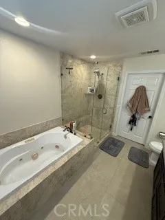 a bathroom with a tub sink a mirror and shower
