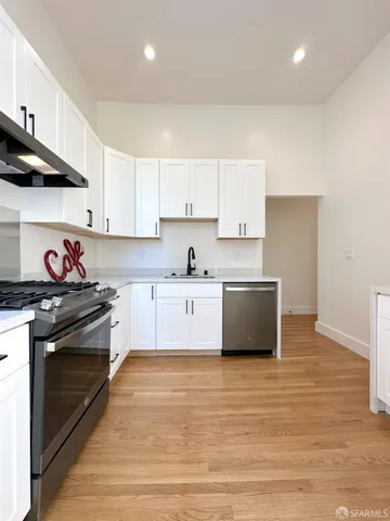 a kitchen with stainless steel appliances granite countertop a stove a sink and a refrigerator