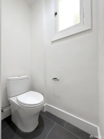 a white toilet sitting next to a sink