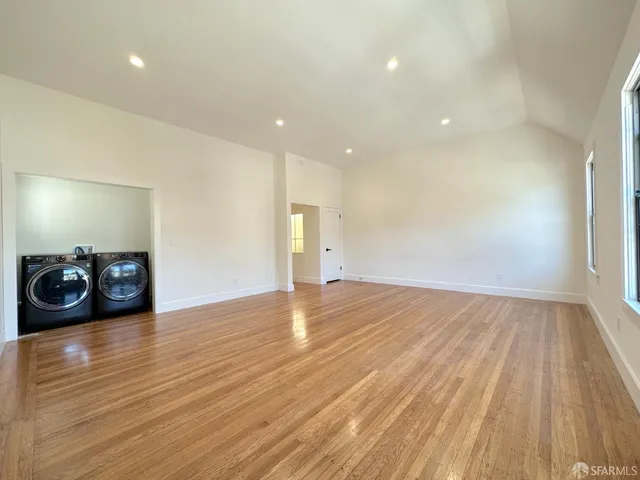 a view of a room with wooden floor