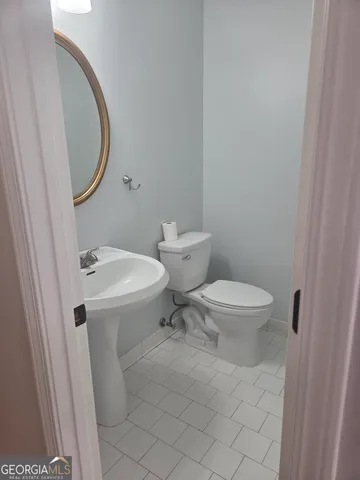 a white toilet sitting next to a bathroom sink