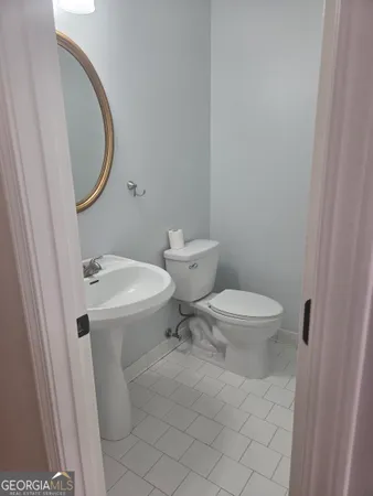 a white toilet sitting next to a bathroom sink