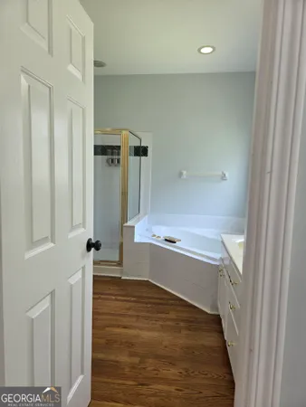 a bathroom with a tub sink and toilet