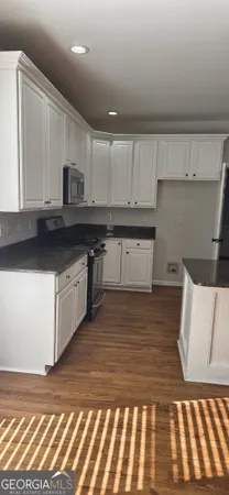 a kitchen with stainless steel appliances granite countertop a sink and cabinets