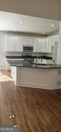 a kitchen with stainless steel appliances granite countertop a sink and cabinets