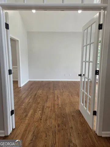 a view of a room with wooden floor and a bathroom