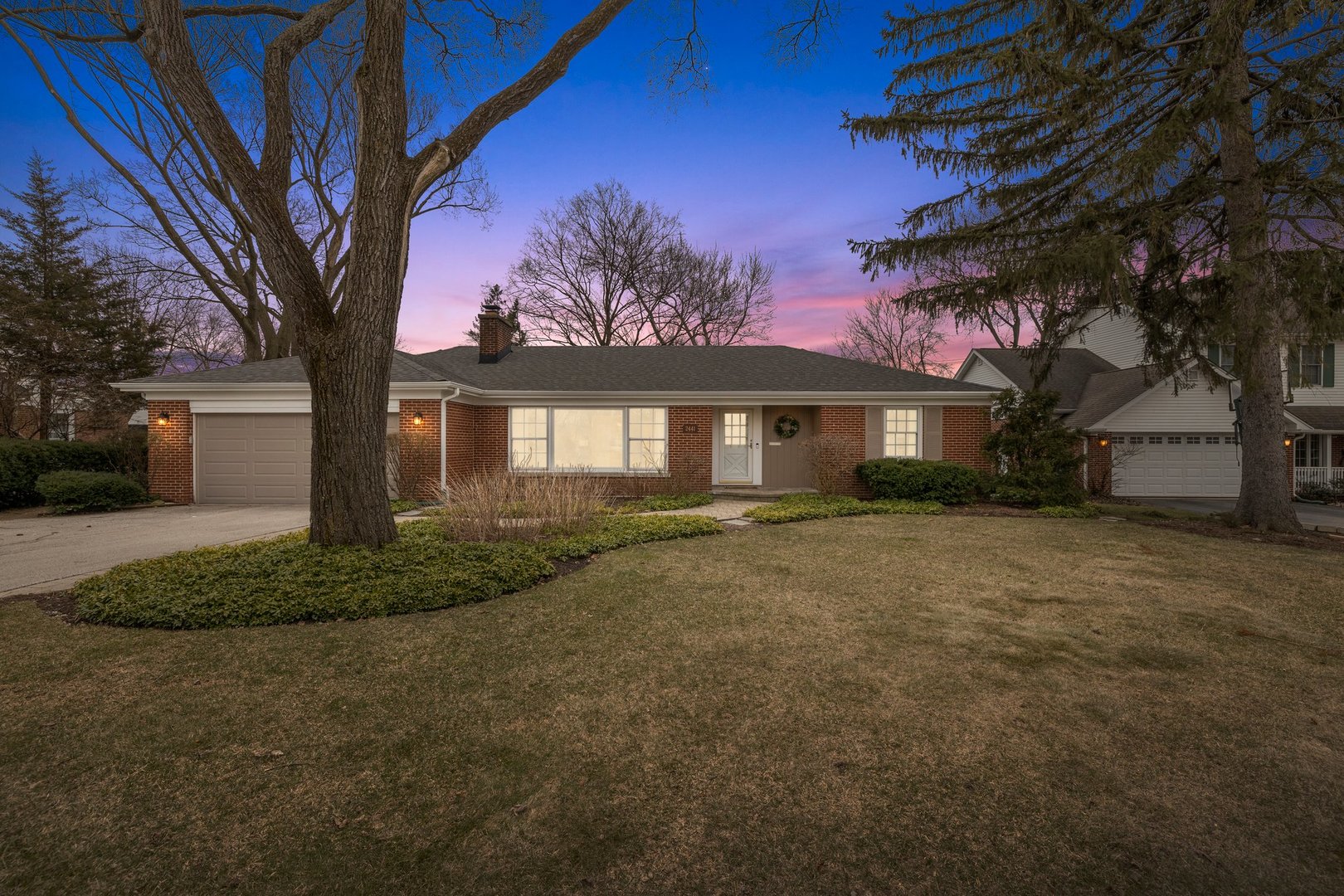 a front view of a house with a garden