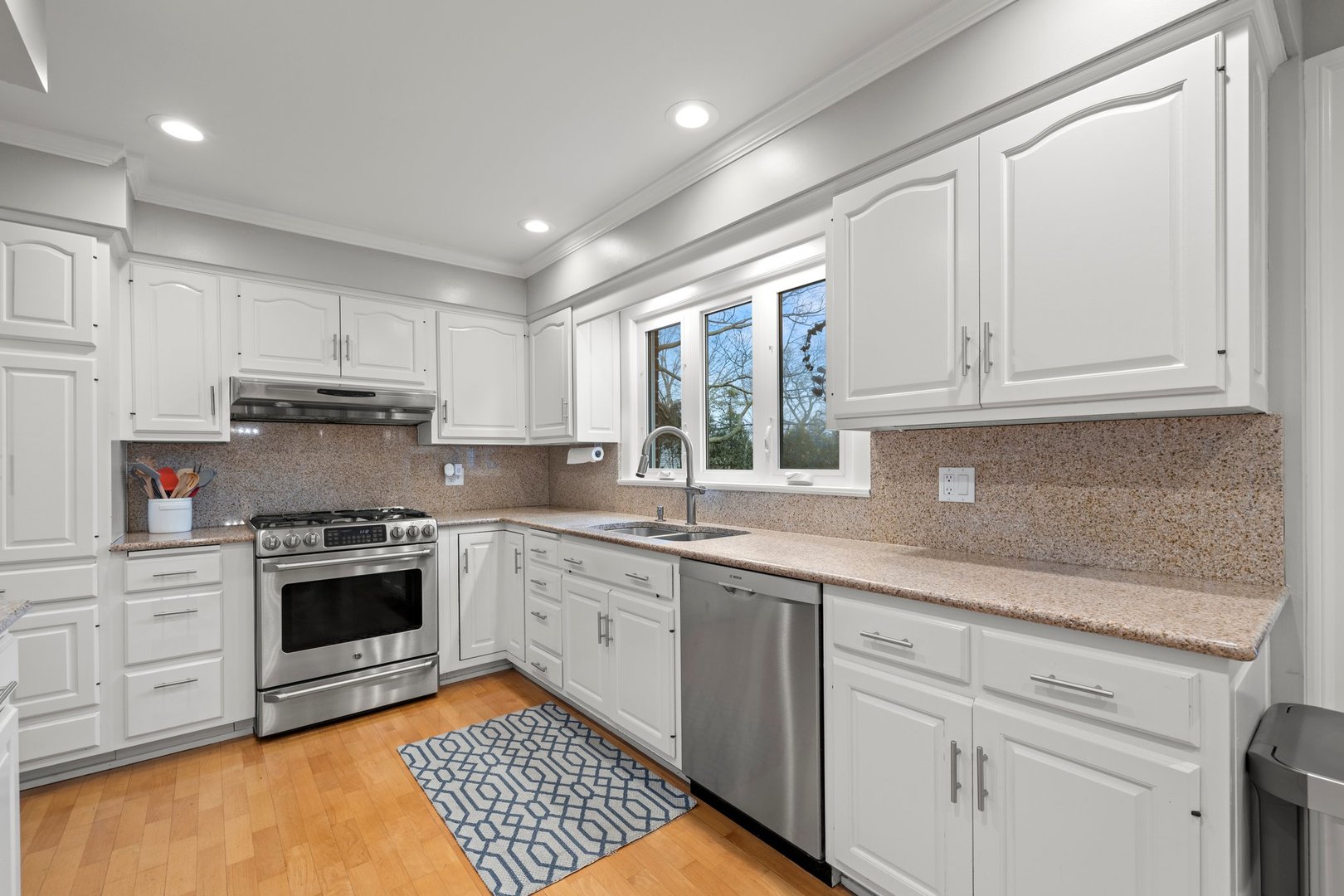 2441 Pick Drive Glenview, IL 60025 - Photo 12 of 43 a kitchen with stainless steel appliances granite countertop a stove sink and cabinets