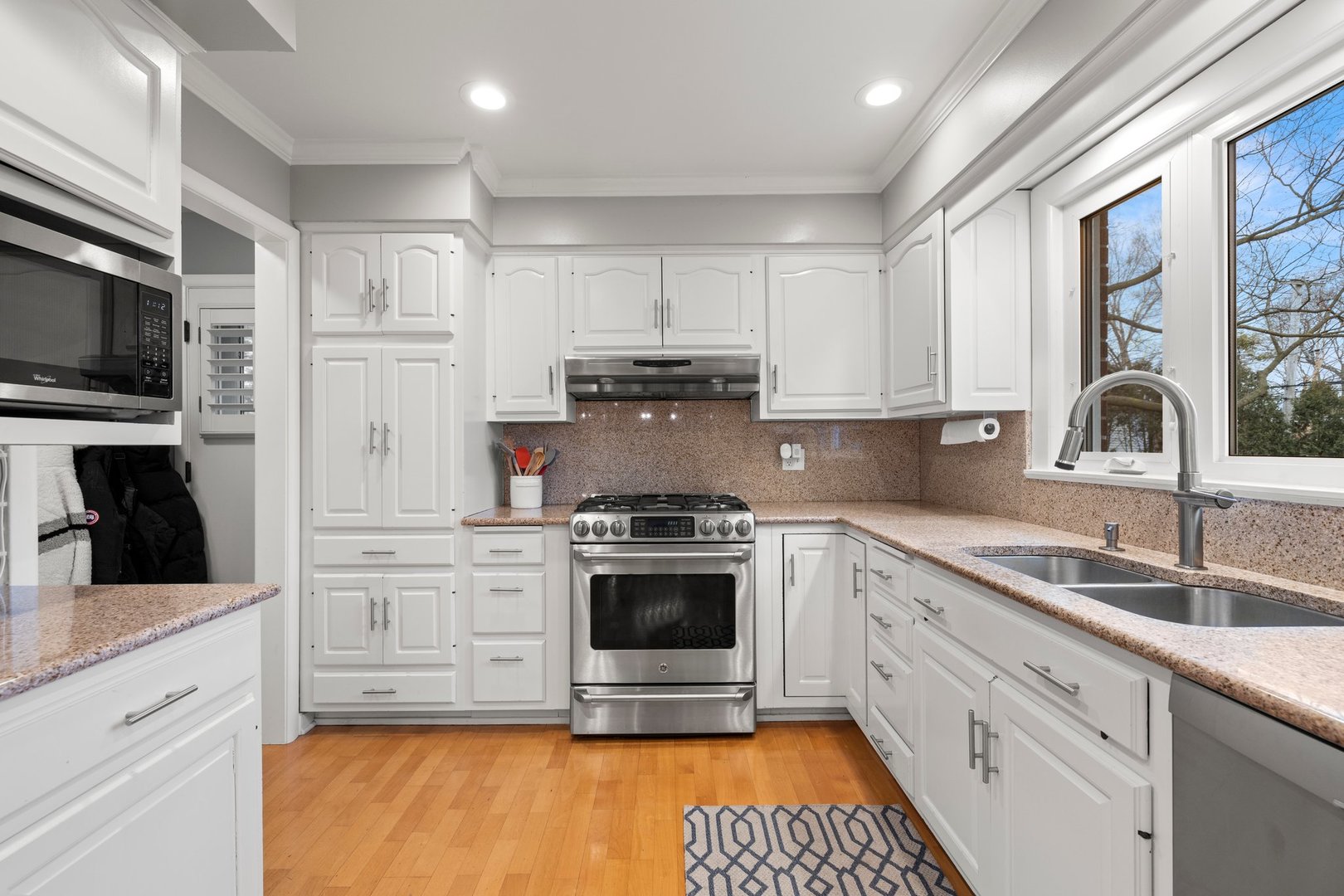 2441 Pick Drive Glenview, IL 60025 - Photo 13 of 43 a kitchen with stainless steel appliances granite countertop a stove a sink and a microwave