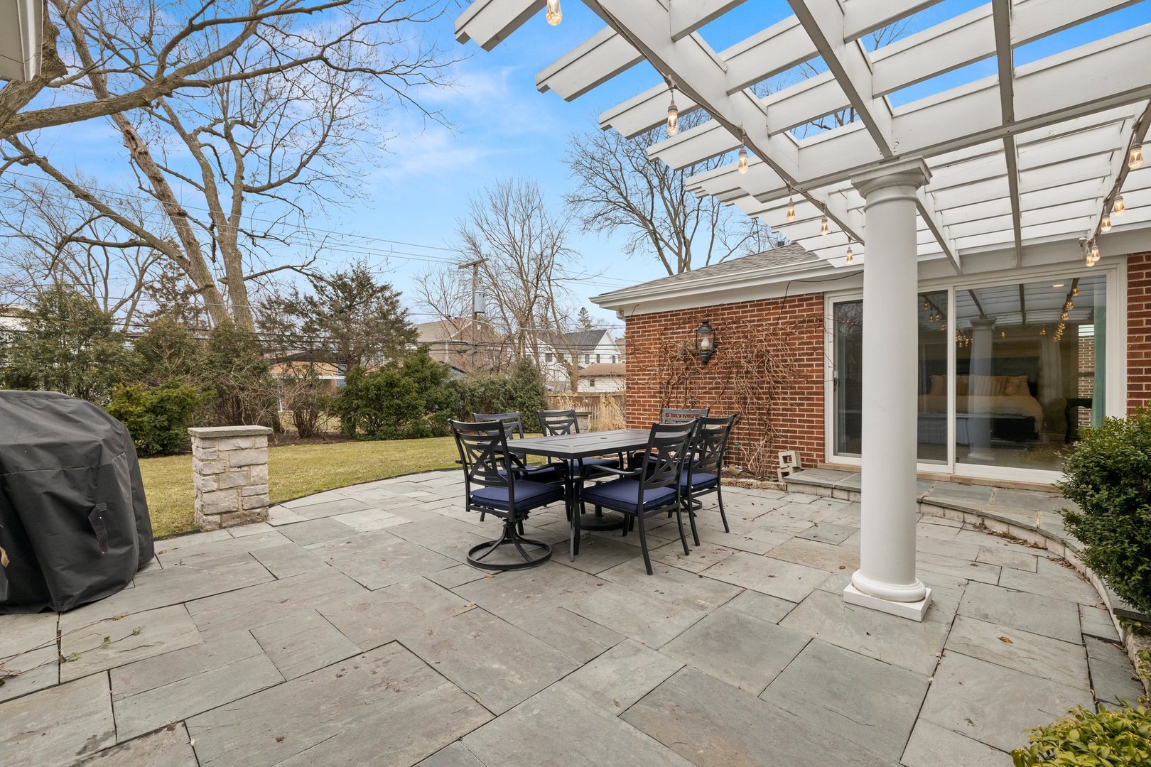2441 Pick Drive Glenview, IL 60025 - Photo 20 of 43 a view of a patio with table and chairs and floor to ceiling window