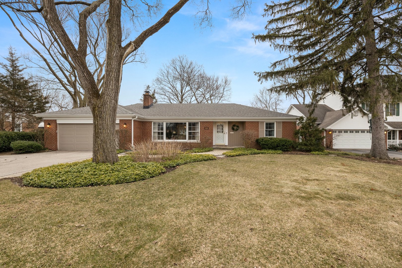 2441 Pick Drive Glenview, IL 60025 - Photo 2 of 43 a front view of a house with a garden