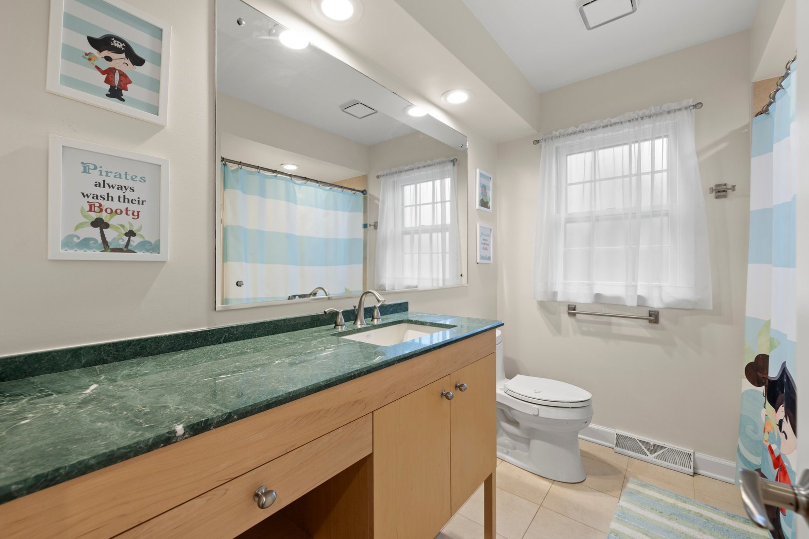 2441 Pick Drive Glenview, IL 60025 - Photo 29 of 43 a bathroom with a granite countertop sink mirror vanity and toilet