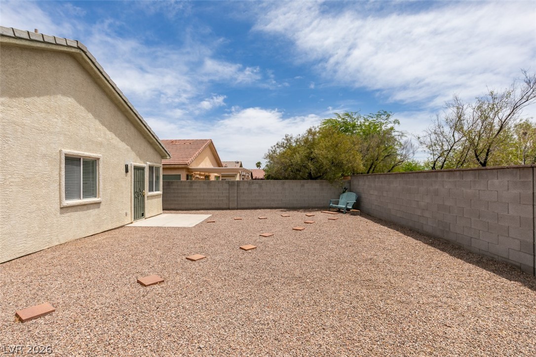 10959 Pumpkin Ridge Avenue Las Vegas, NV 89135 - Photo 34 of 51 A spacious backyard with a patio provides ample space for outdoor enjoyment.