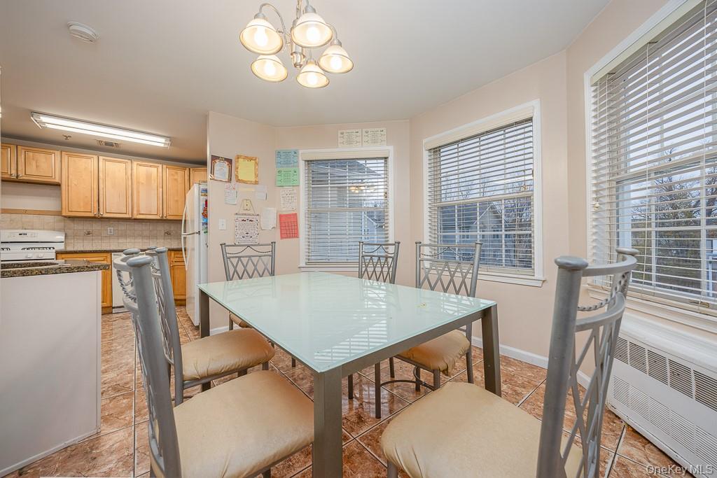 3 Horizon Court, Unit 304 Monsey, NY 10952 - Photo 15 of 36 a view of a dining room with furniture and a chandelier