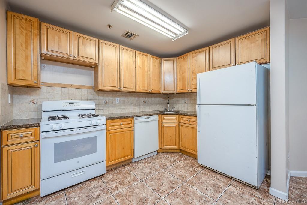 3 Horizon Court, Unit 304 Monsey, NY 10952 - Photo 17 of 36 a kitchen with a refrigerator sink stove and cabinets