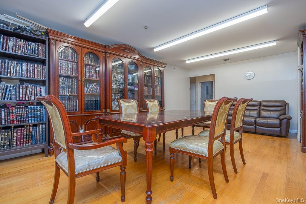 3 Horizon Court, Unit 304 Monsey, NY 10952 - Photo 21 of 36 a view of a dining room with furniture and a book shelf