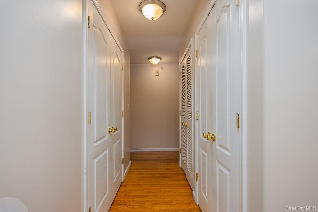 3 Horizon Court, Unit 304 Monsey, NY 10952 - Photo 22 of 36 a view of a hallway with wooden floor and a bathroom