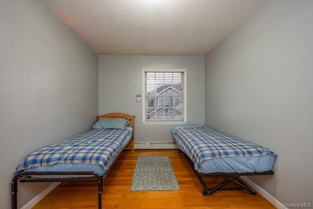 3 Horizon Court, Unit 304 Monsey, NY 10952 - Photo 29 of 36 a bedroom with two beds and wooden floor