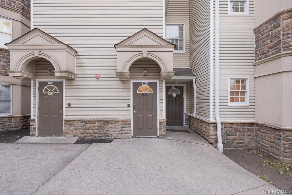 3 Horizon Court, Unit 304 Monsey, NY 10952 - Photo 4 of 36 a front view of a house with garage