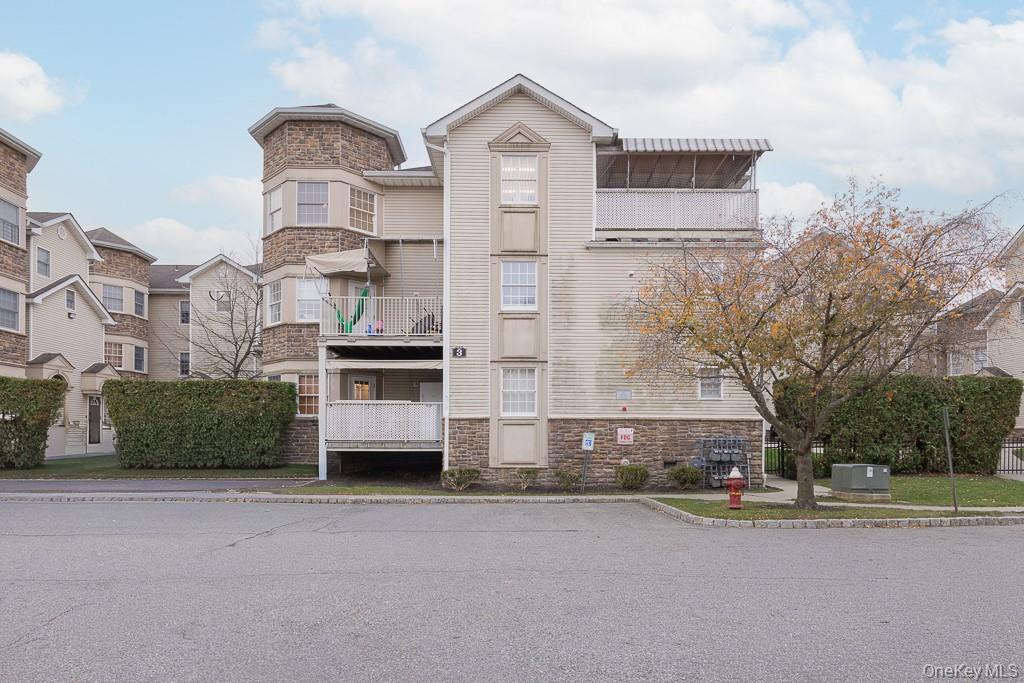 3 Horizon Court, Unit 304 Monsey, NY 10952 - Photo 7 of 36 a front view of a house with a yard and garage