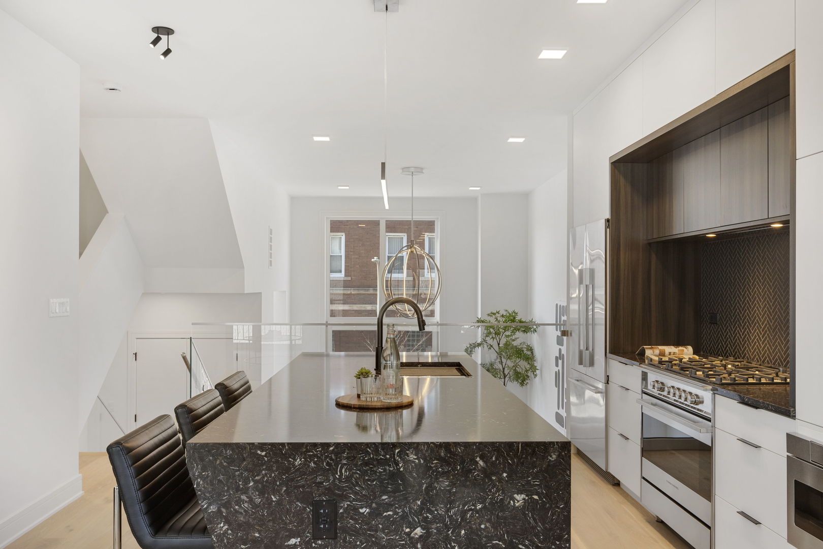 336 East Pershing Road Chicago, IL 60653 - Photo 13 of 86 a kitchen with kitchen island granite countertop a sink and a stove top oven