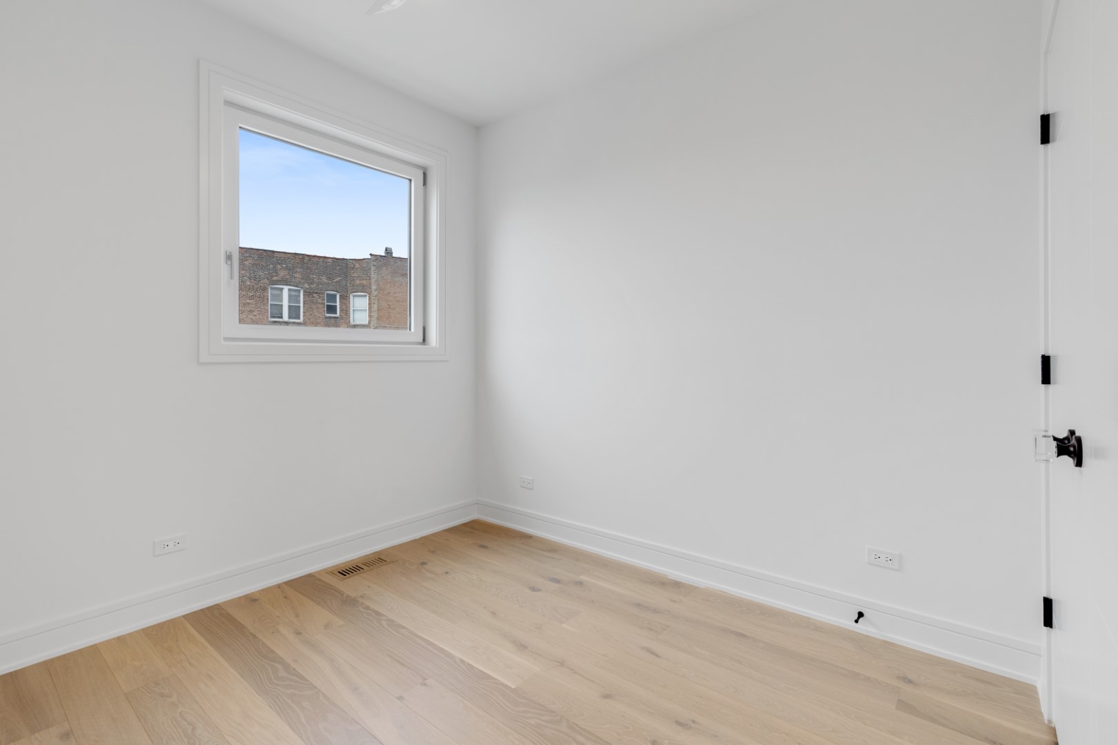 336 East Pershing Road Chicago, IL 60653 - Photo 53 of 86 a view of an empty room with wooden floor and a window