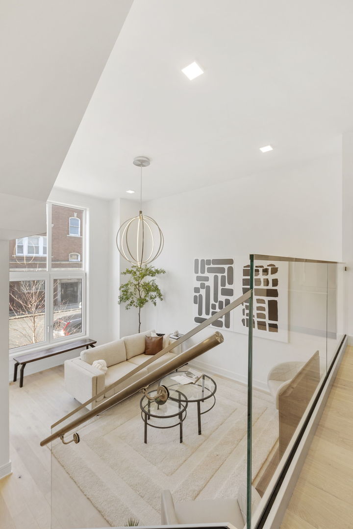 336 East Pershing Road Chicago, IL 60653 - Photo 9 of 86 a living room with furniture a chandelier and a large window