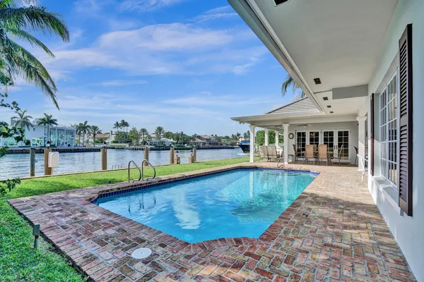 a patio with a table and chairs