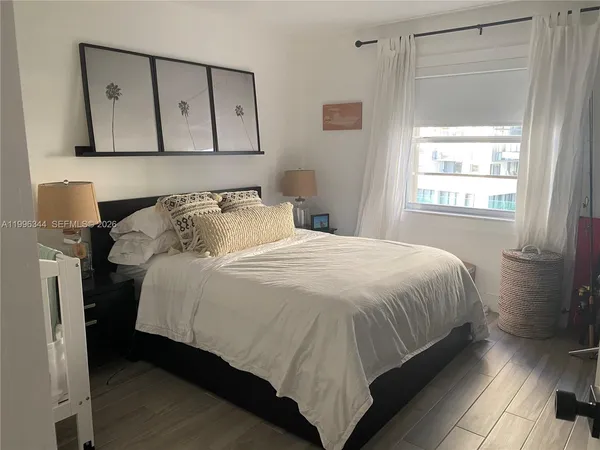 a bedroom with a bed and window