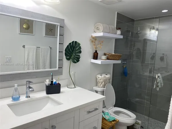 a bathroom with a sink toilet and shower