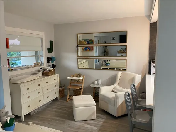 a living room with furniture cabinets and window