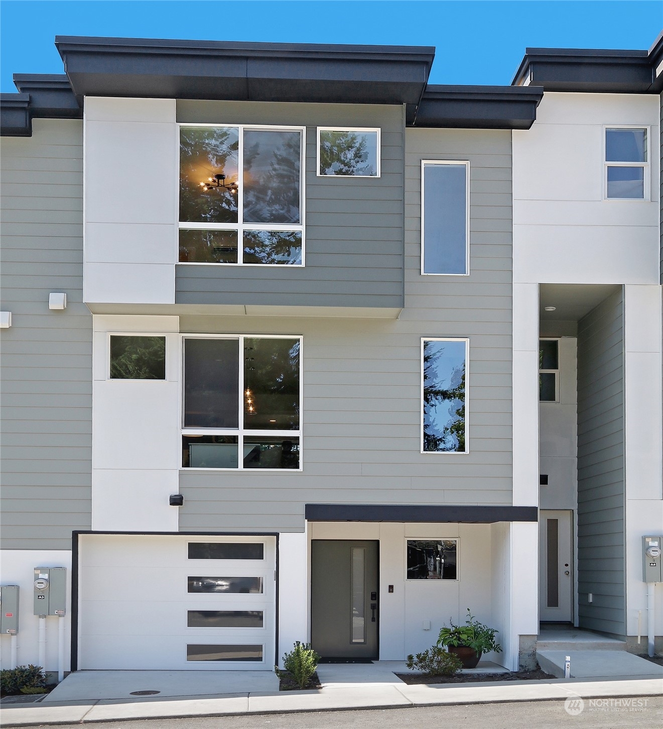 a front view of a house with a yard and parking space