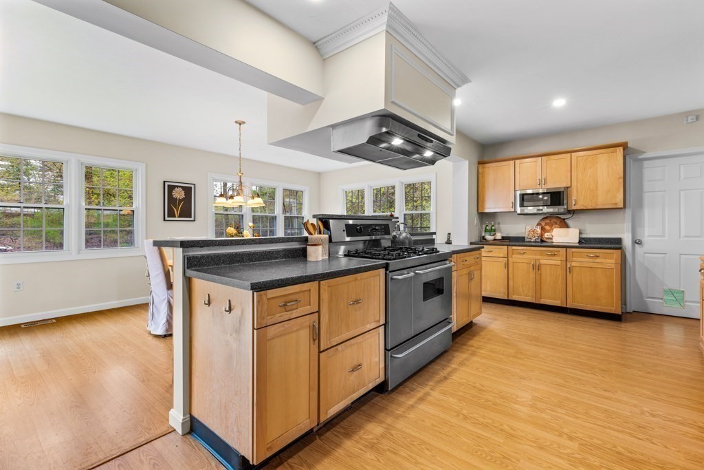 55 Hickory Road Sudbury, MA 01776 - Photo 11 of 42 a kitchen with stainless steel appliances granite countertop a stove a sink and a refrigerator