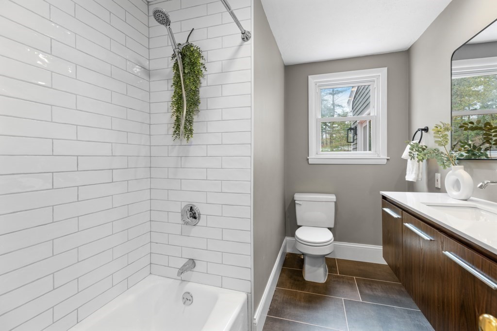 55 Hickory Road Sudbury, MA 01776 - Photo 15 of 42 a bathroom with a granite countertop toilet a sink and bathtub