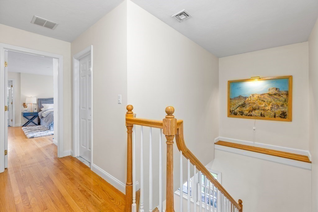 55 Hickory Road Sudbury, MA 01776 - Photo 19 of 42 a view of a hallway with wooden floor and stairs
