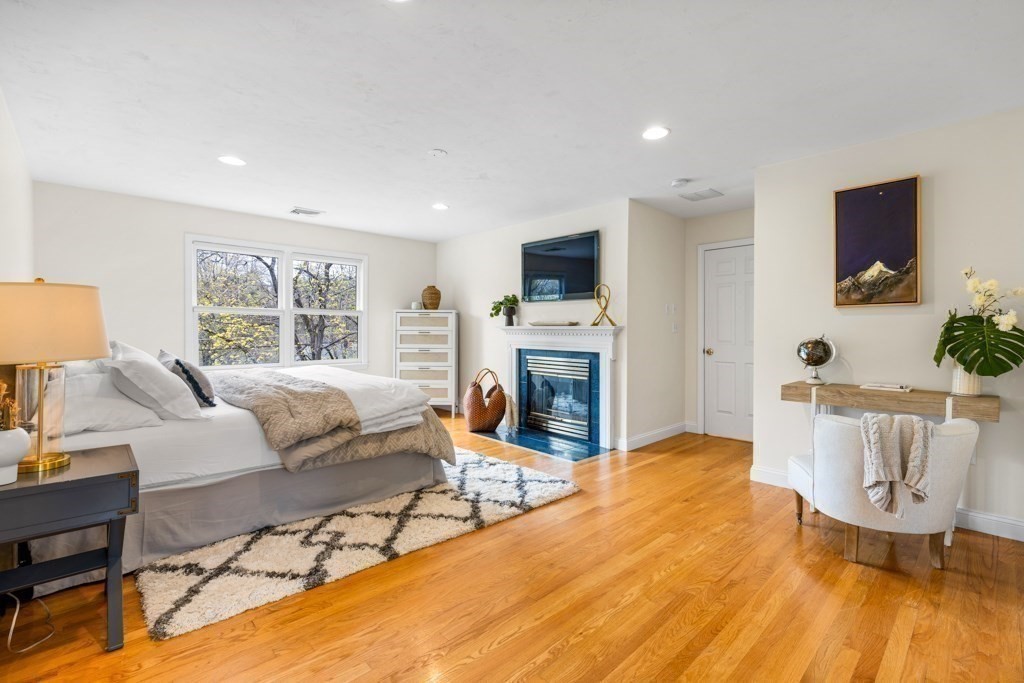 55 Hickory Road Sudbury, MA 01776 - Photo 20 of 42 a living room with furniture a fireplace and a flat screen tv