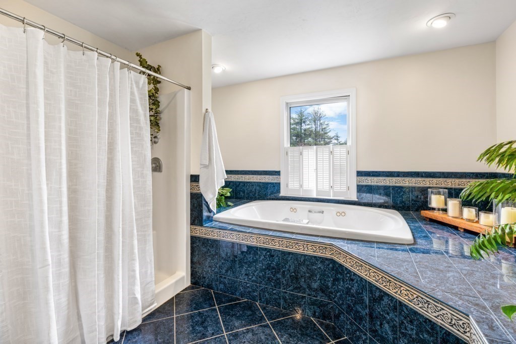 55 Hickory Road Sudbury, MA 01776 - Photo 23 of 42 a spacious bathroom with a granite countertop sink and a mirror