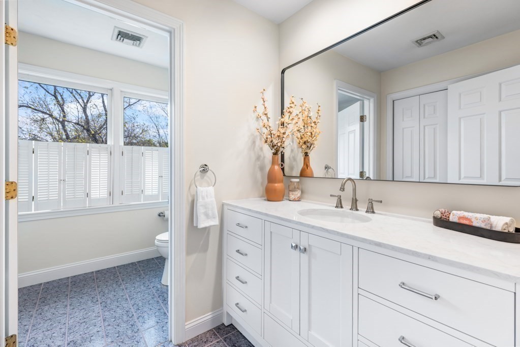 55 Hickory Road Sudbury, MA 01776 - Photo 26 of 42 a bathroom with a double vanity sink a mirror and a bathtub