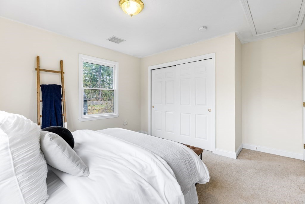55 Hickory Road Sudbury, MA 01776 - Photo 29 of 42 a bedroom with a bed and a large window